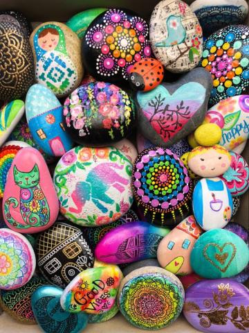 painted rocks showing a variety of colors and designs